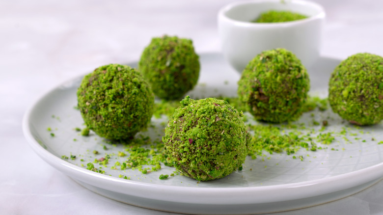Pistachio truffles on a white plate
