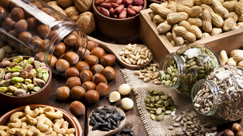 Assorted whole nuts and seeds on a burlap napkin