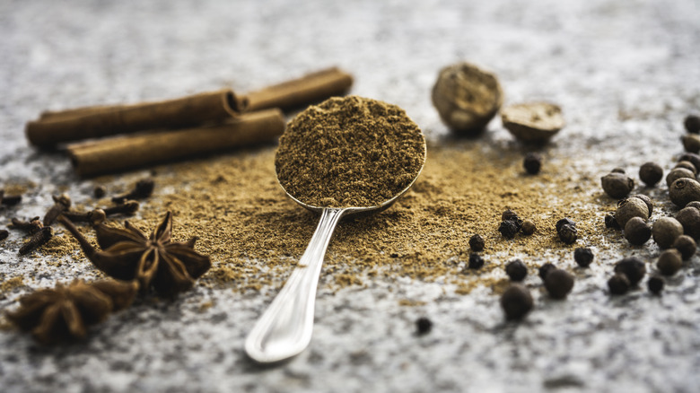 Pumpkin spice ingredients on a counter with a spoon