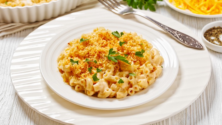 Plate of mac and cheese with breadcrumbs on top