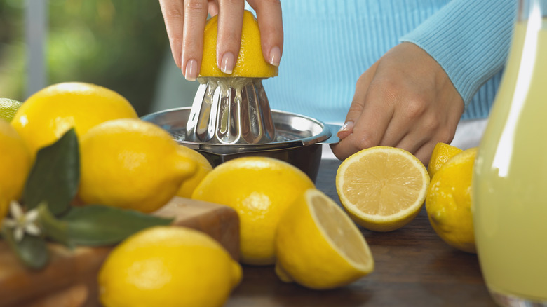 Fresh lemons being squeezed