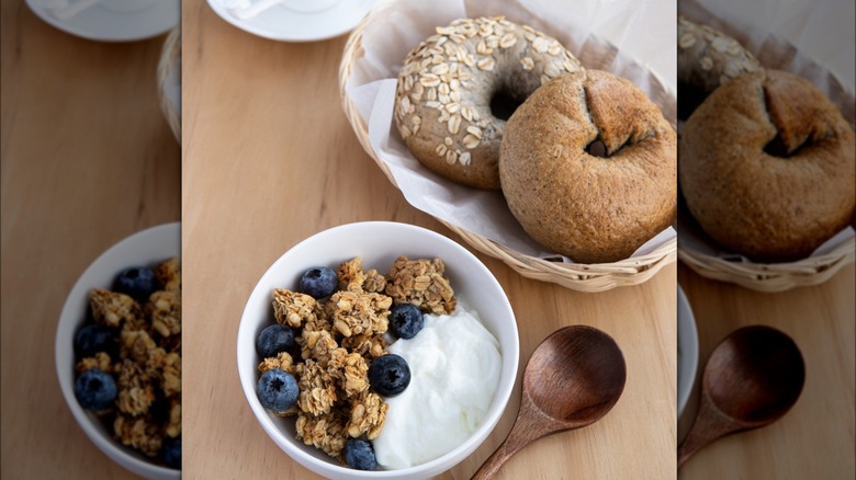 Greek yogurt in bowl and bagels in basket