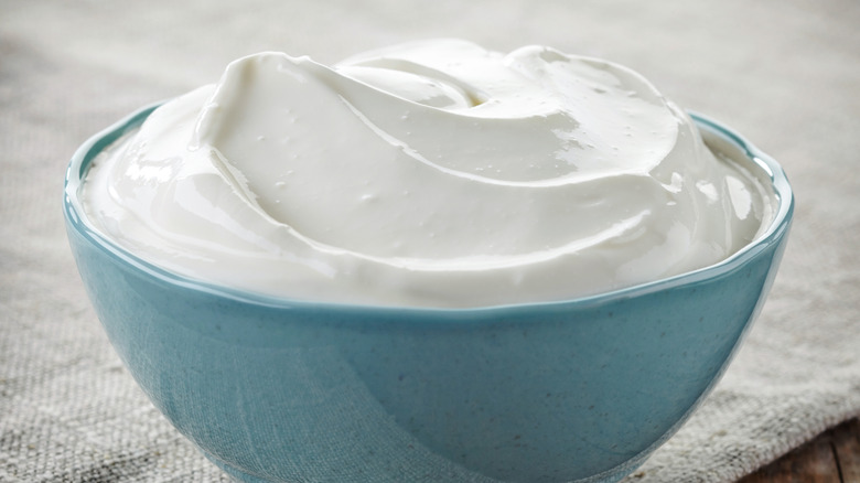 Sour cream in blue bowl with napkin