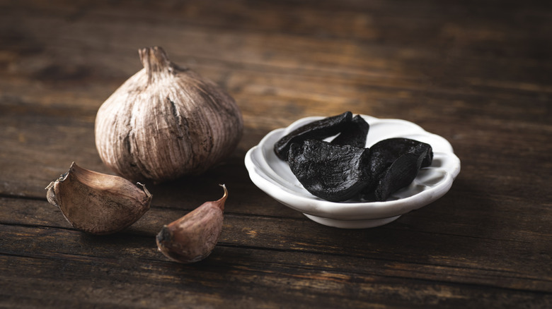 black garlic on wooden background