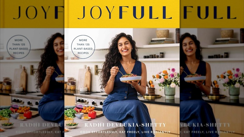 Deluvkia in her kitchen on her cookbook cover