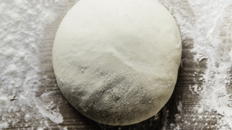 pizza dough on floured board