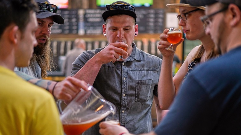 A group of people sipping on beer samples