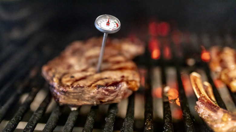 Steak on the grill with a meat probe