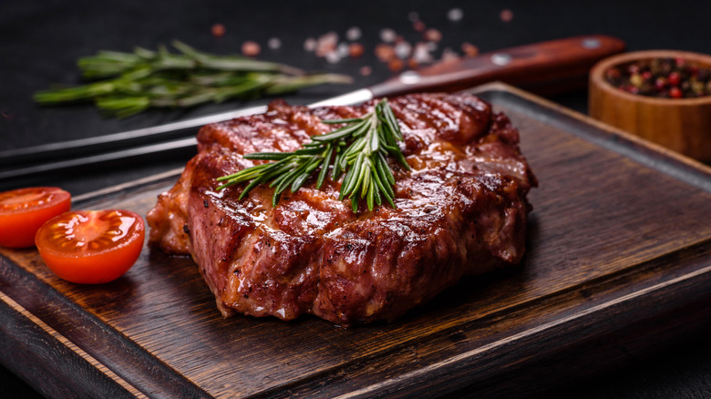 Cooked steak resting on a cutting board