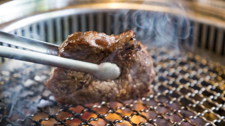 Steak being seared on a grill