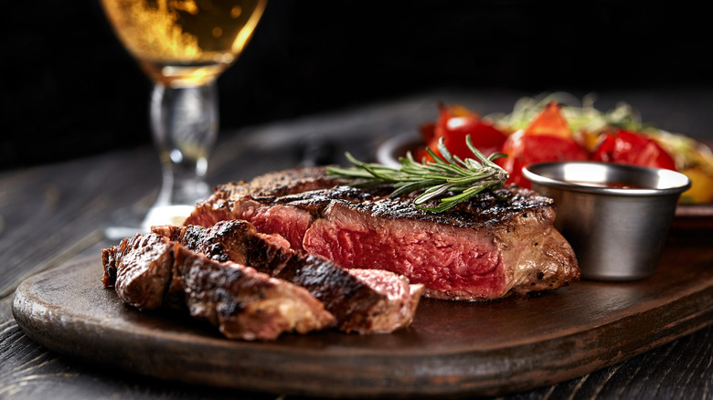 Medium rare steak on a cutting board