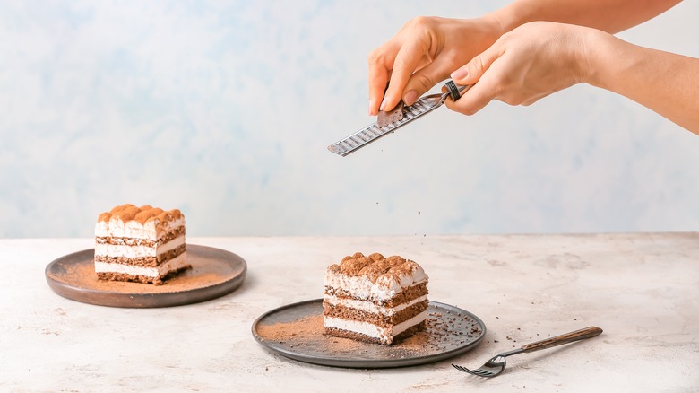 Grating chocolate over a cake