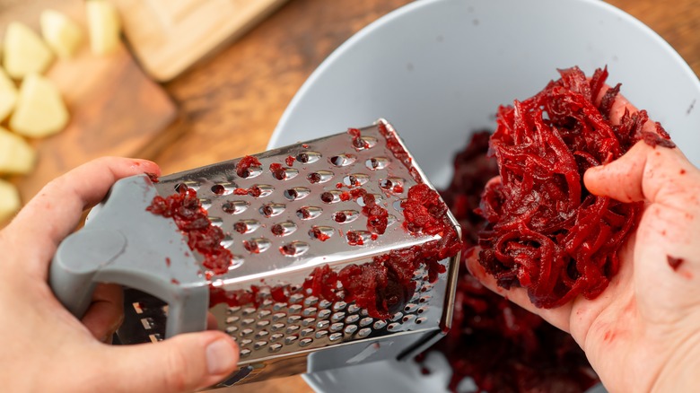 Grating beetroots into a bowl