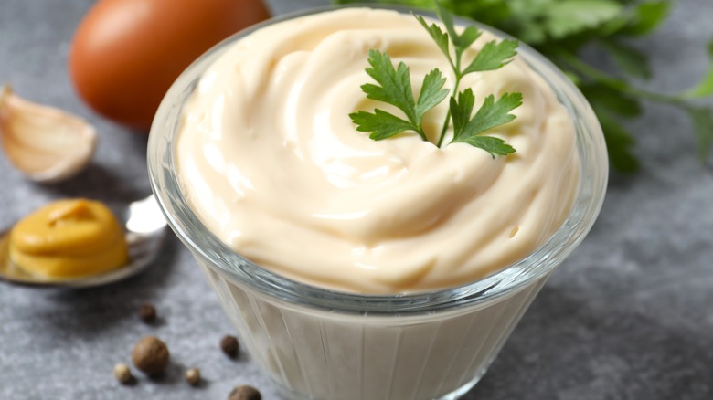 A small jar of mayonnaise with a garnish