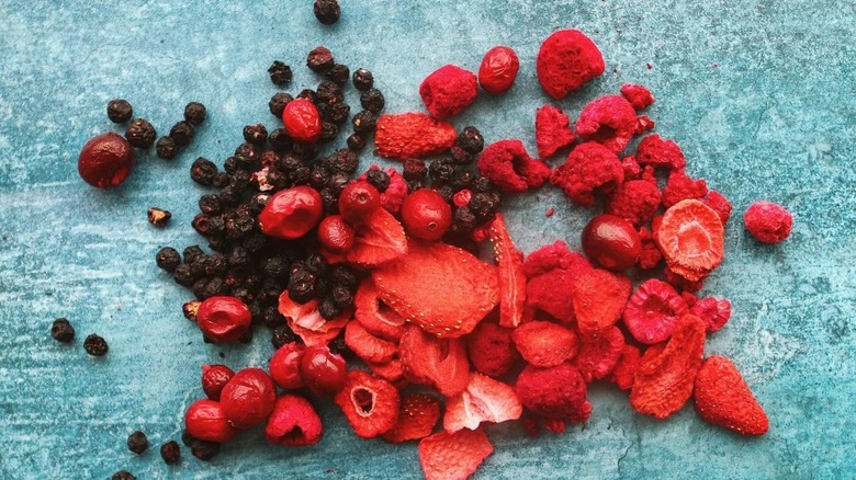 Freeze-dried berries spilled on a blue countertop