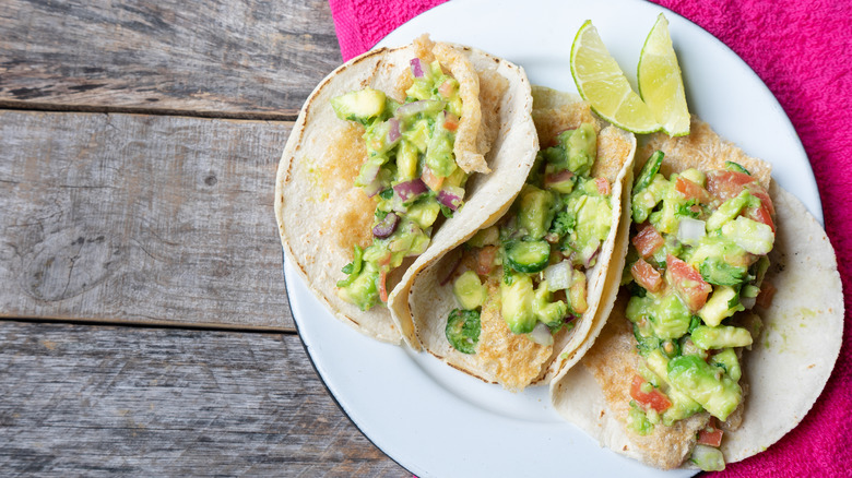 Three tacos placeros with chicharron and avocado