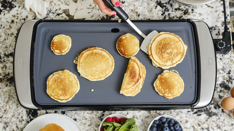 flipping pancakes on electric griddle
