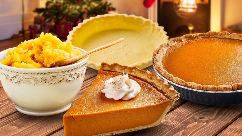 There are pumpkin pie ingredients and baked pies sitting on a wooden table.on table