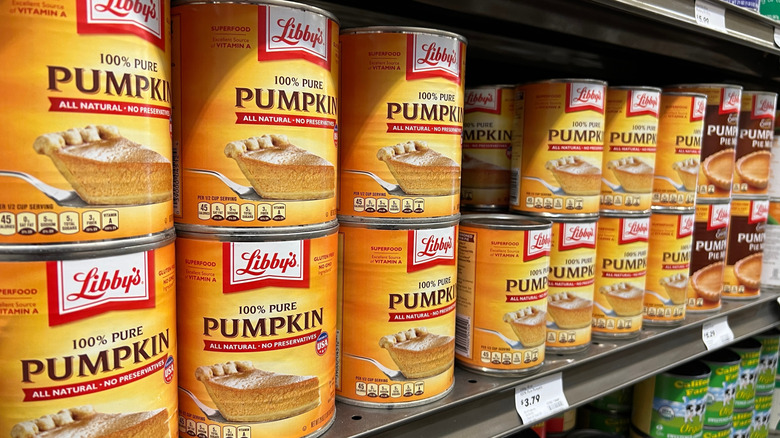 A row of cans of pumpkin pie filling are at the store.