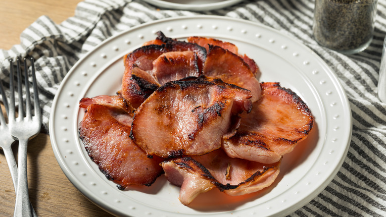 crisped Canadian bacon on plate