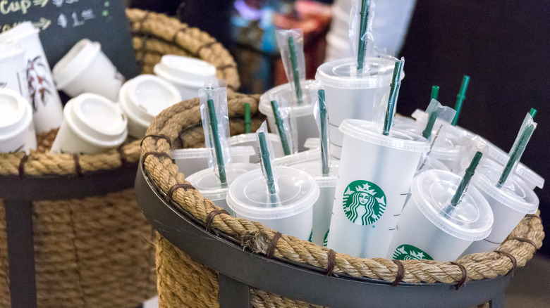 basket of reusable Starbucks cups