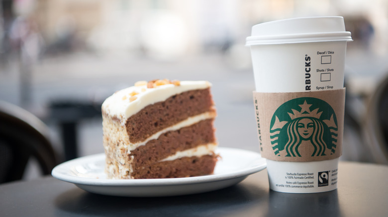 Starbucks cup next to cake