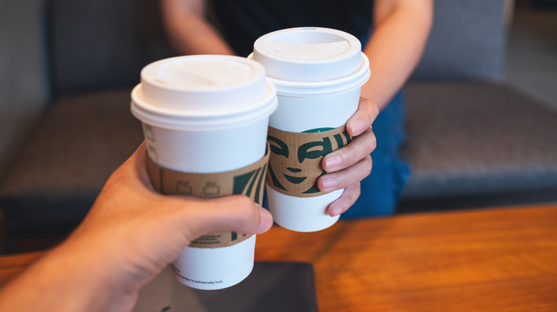 clinking Starbucks cups