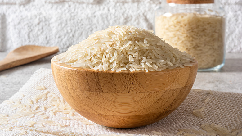 A bowl of dried rice in a wooden bowl