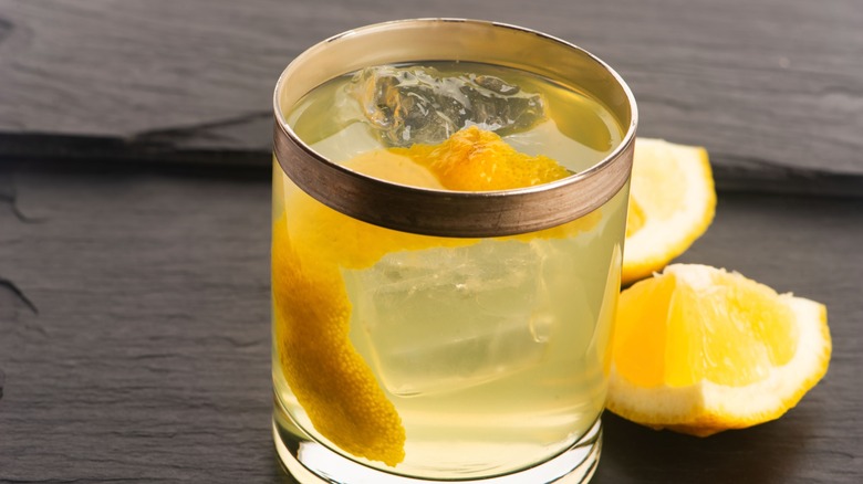 Clarified milk punch sits on a wood table.