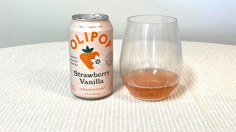 a can of Strawberry Vanilla Olipop beside a glass containing a sample
