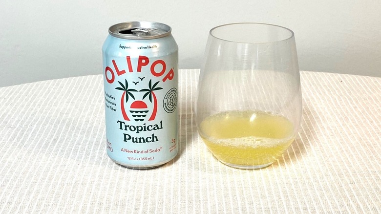 a can of Tropical Punch Olipop sits on a table beside a sample in a glass