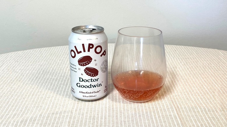 a can Olipop Doctor Goodwin sitting beside a glass containing a small sample