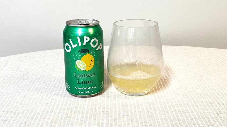 a green can of Lemon Lime Olipop sitting beside a sample in a glass