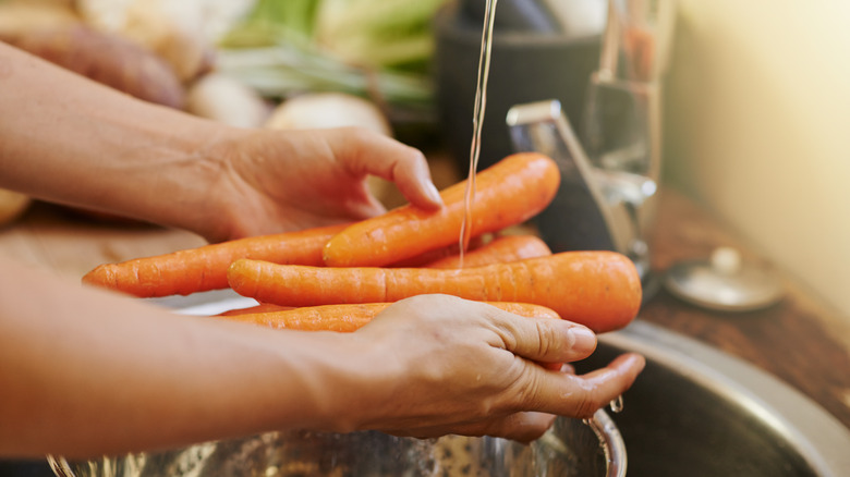 hands washing carrots
