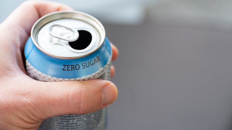 hand holding zero sugar soda