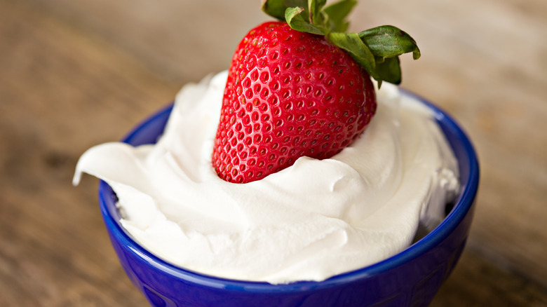 strawberry in whipped cream bowl