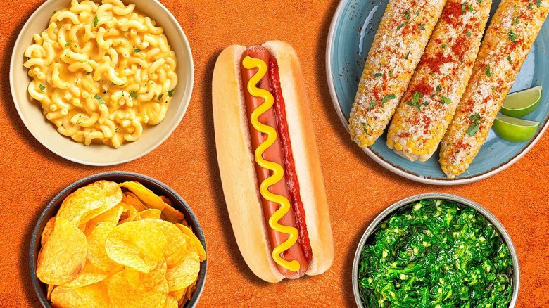 hot dog surrounded with assorted toppings