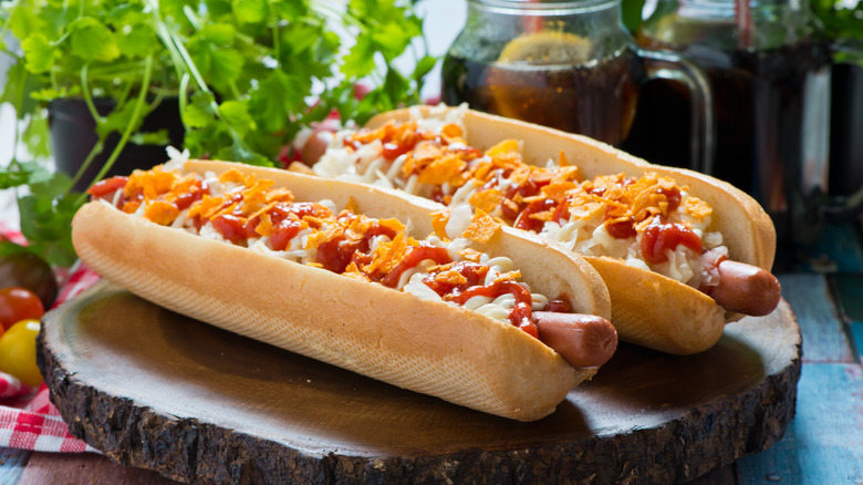 Hot dogs topped with mayo, ketchup, and crushed potato chips