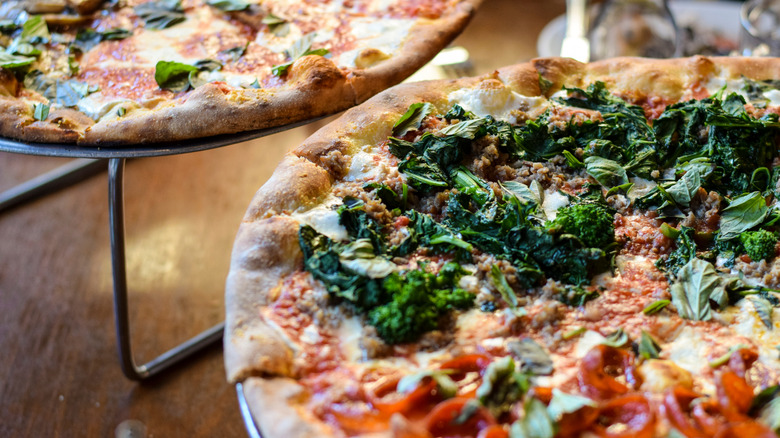 A close-up shot of a pizza with broccoli rabe