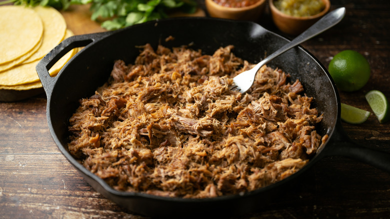 A skillet filled with pork carnitas