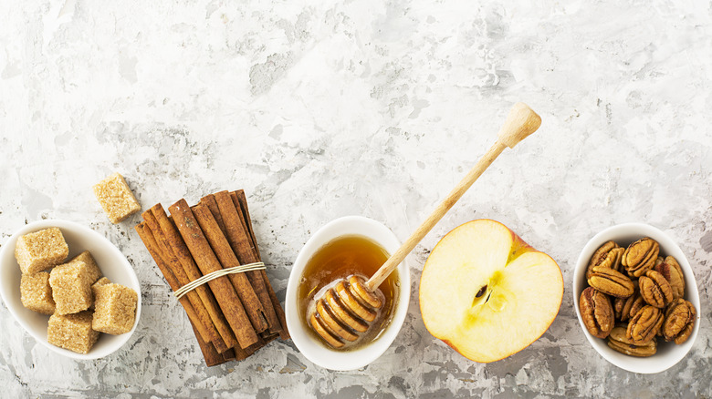 Apples, pecans, syrup, and cinnamon sticks