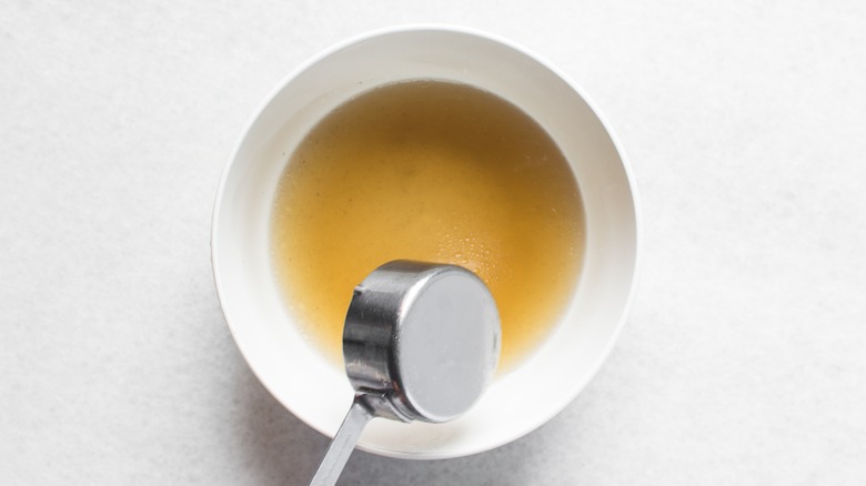 Chicken broth poured into a white bowl