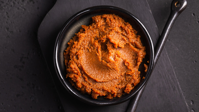 Bowl of miso paste on black table