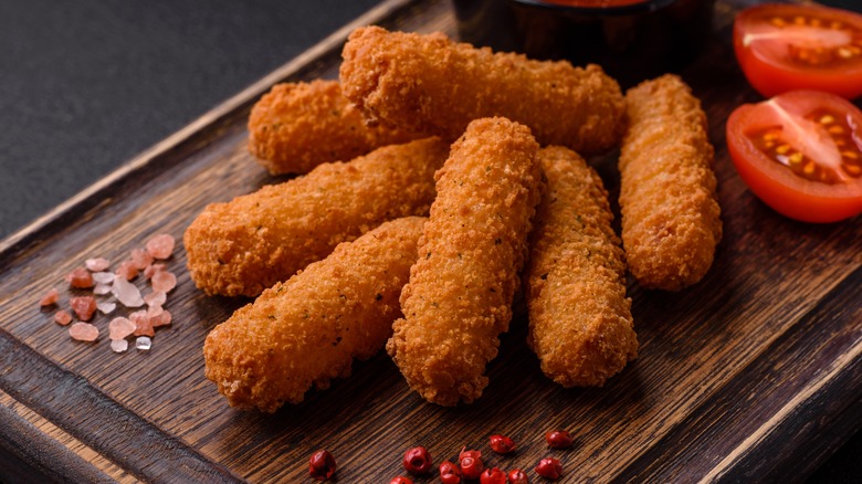 mozzarella sticks on a cutting board