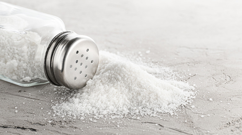 A salt shaker spilling out salt