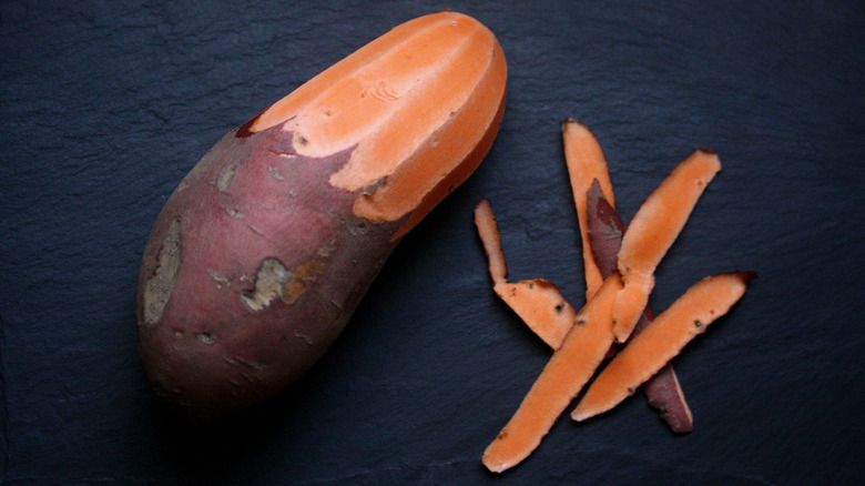 A half-peeled sweet potato