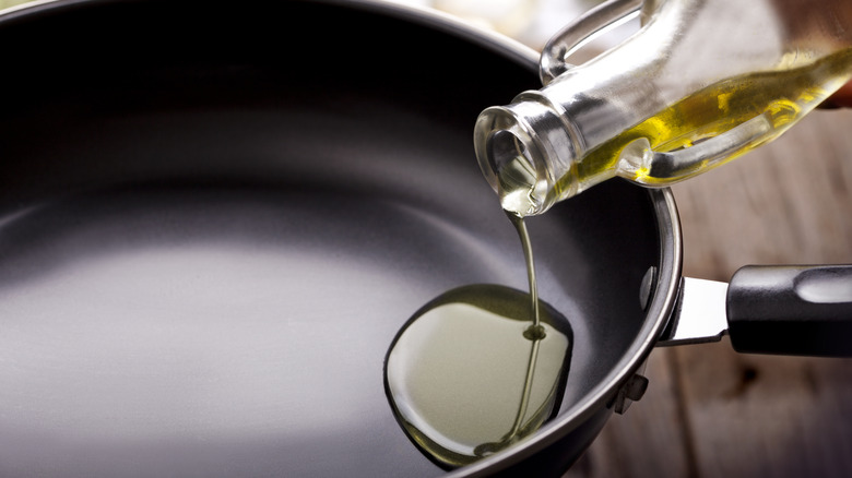 Pouring olive oil into a pan