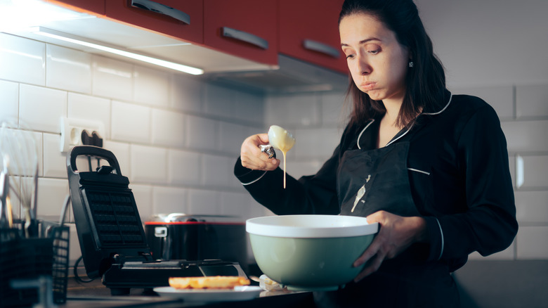 Frustrated woman in kitchen