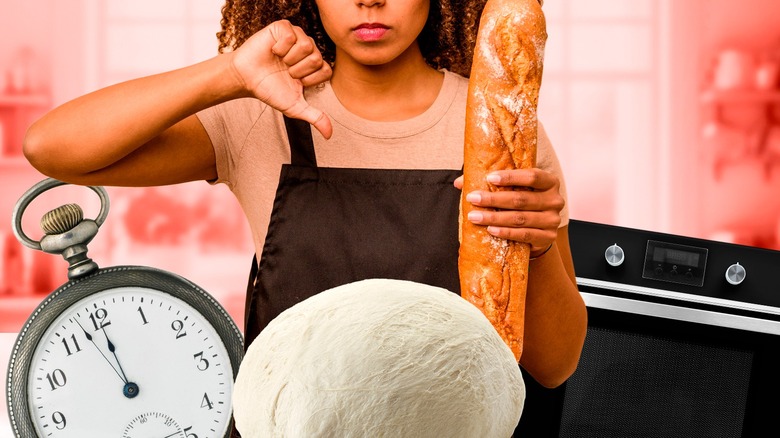 Woman holding baguette giving thumbs down