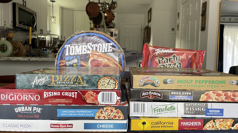 Assorted pizza brands stacked